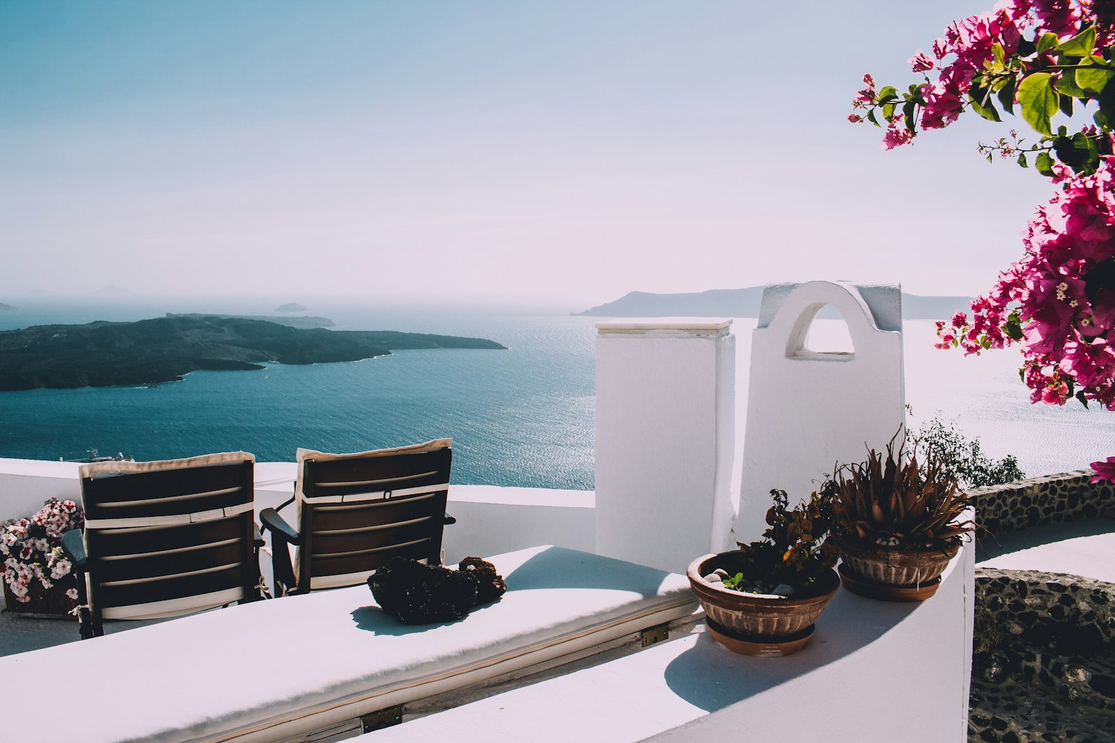 Whitewashed Cycladic architecture with smooth curved walls against a blue sky