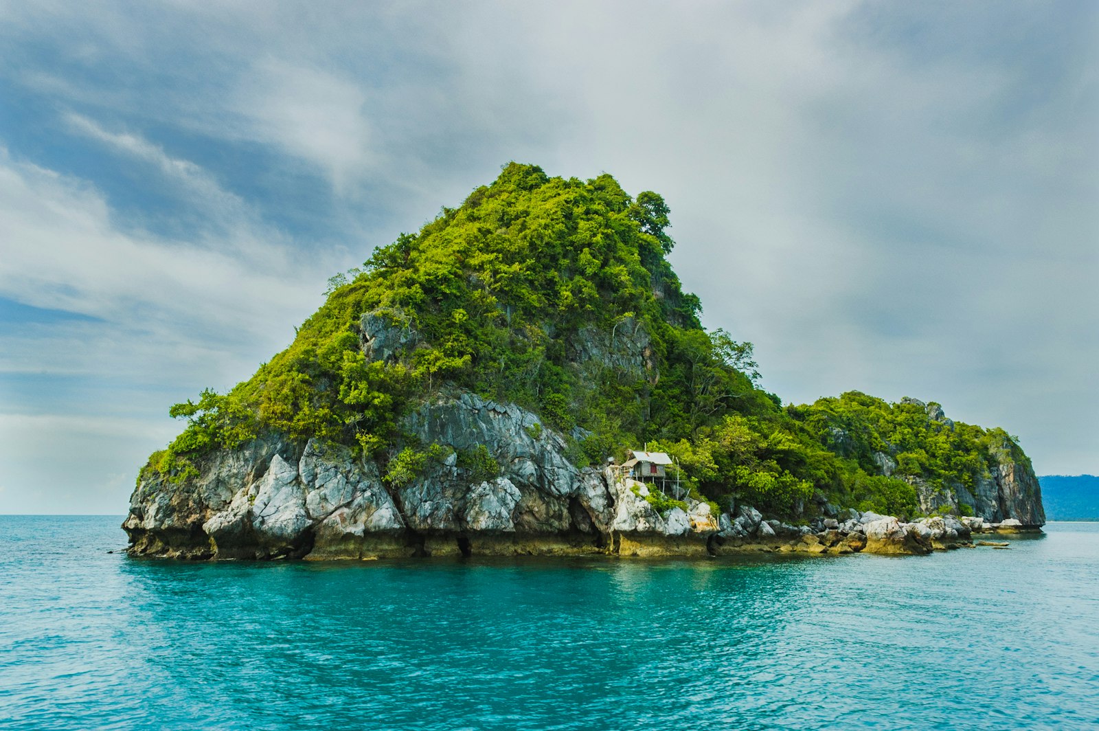 A turquoise Ionian cove backed by olive-covered hills on the Albanian Riviera