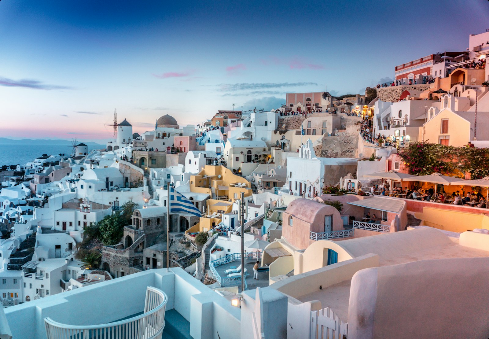 Whitewashed cave suites carved into the Santorini caldera above the sea